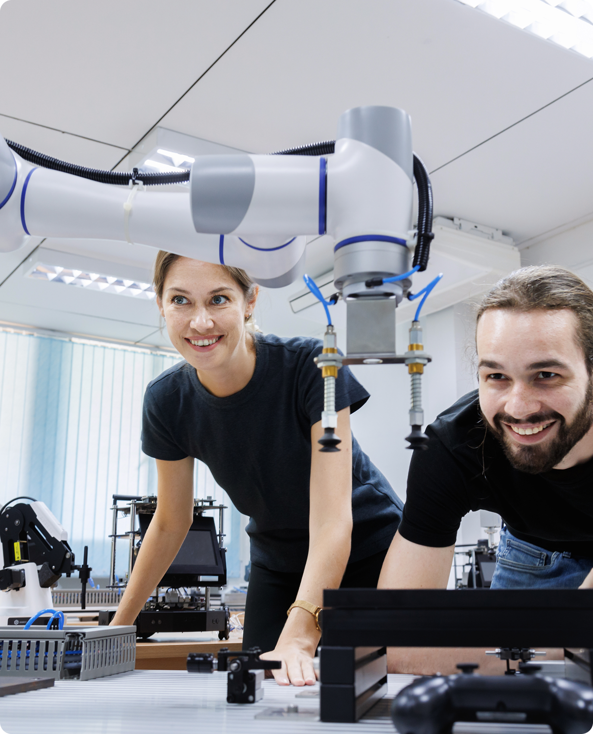 People working with robotic arm